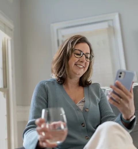 woman relaxing on couch looking at phone